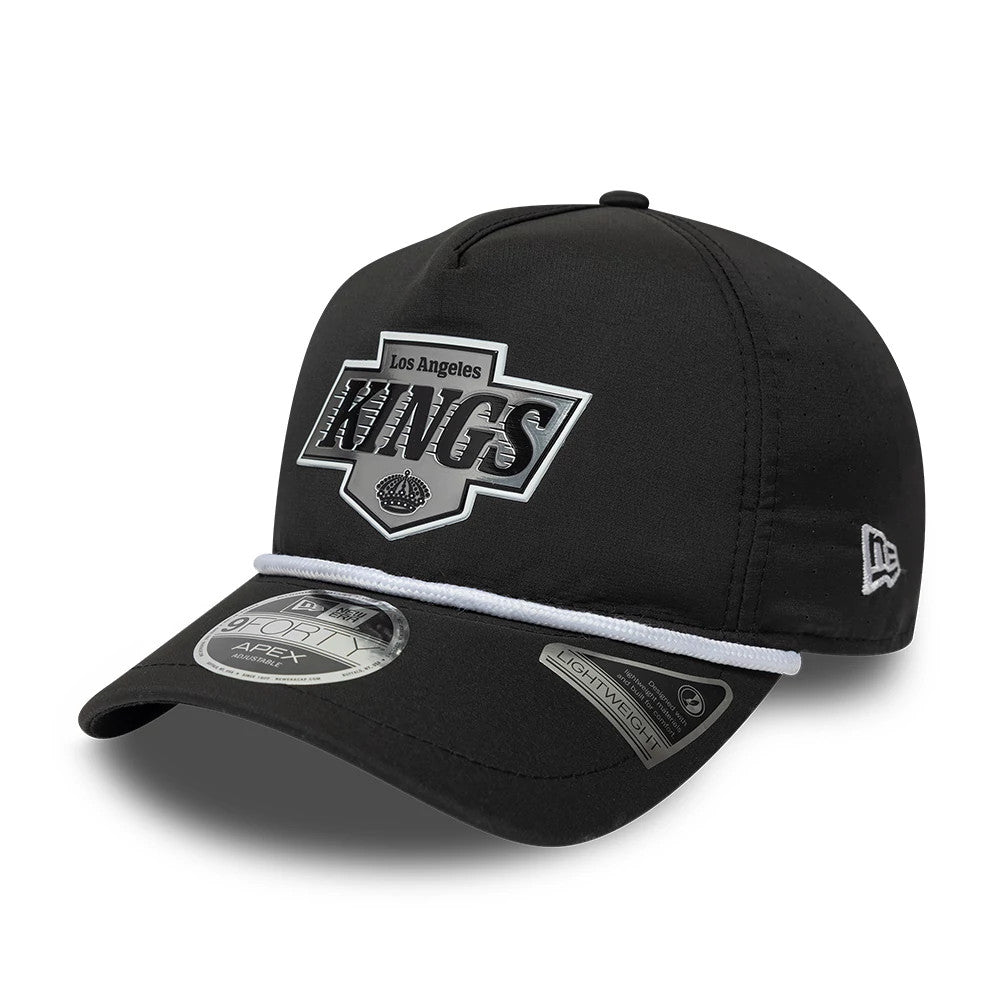 LA Kings NHL Quickstrike Black New Era 9FORTY Apex Adjustable Cap, front view showing a large silver Kings logo on the front panel, a white rope trim across the black curved visor, and a New Era flag logo embroidered on the left side.