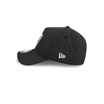 Raiders NFL Quickstrike Black New Era 9FORTY Apex Adjustable Cap, side view showing the white embroidered New Era flag logo on the left side, a curved black visor with a 9FORTY size sticker, and a structured black crown.