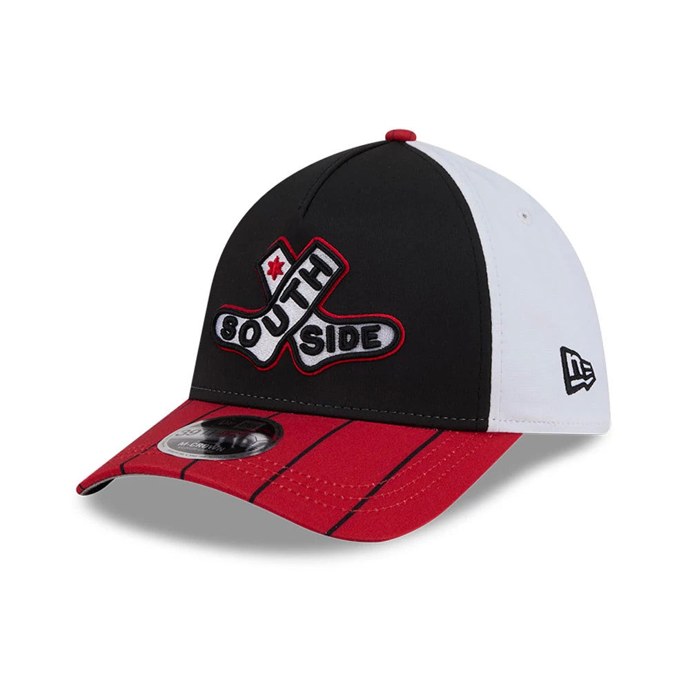 White Sox MLB City Connect Black New Era 39THIRTY M-Crown A-Frame Stretch Fit Cap, three-quarter view showing the South Side logo in black, white, and red embroidery on the front panel, red striped visor and the New Era flag on the left side.