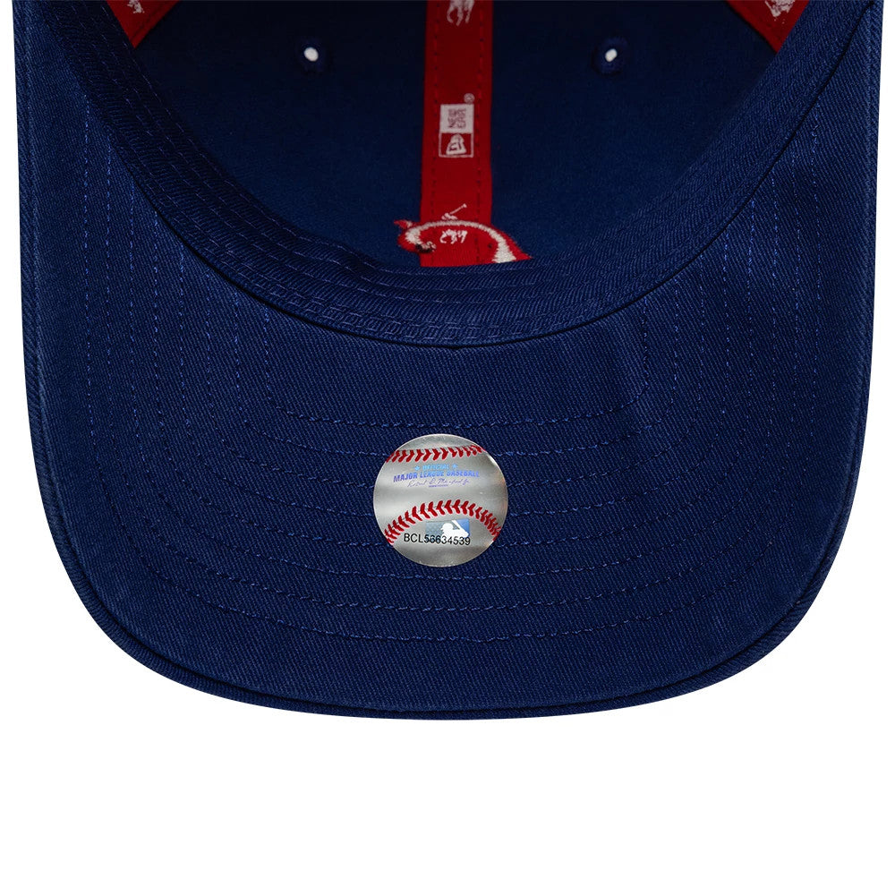 Chicago Cubs Ralph Lauren X MLB Dark Blue New Era 9TWENTY Adjustable Cap, inside view showing the dark blue undervisor with red MLB and Polo Ralph Lauren branded taping along the seams, plus a round baseball-themed sticker at the centre.