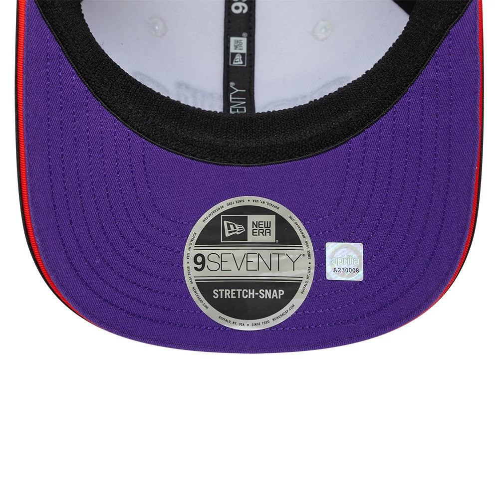 Aprilia Replica Marco Bezzecchi White New Era 9SEVENTY Stretch Snap Adjustable Cap, inside view showing a purple undervisor with a 9SEVENTY size sticker, black edge stitching, and taping with branding details.