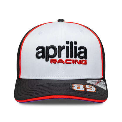 Aprilia Replica Jorge Martin White New Era 9SEVENTY Stretch Snap Adjustable Cap, front view showing black and red embroidered aprilia RACING logo on the white structured crown, black curved visor with 89 graphic and a 9SEVENTY size sticker.