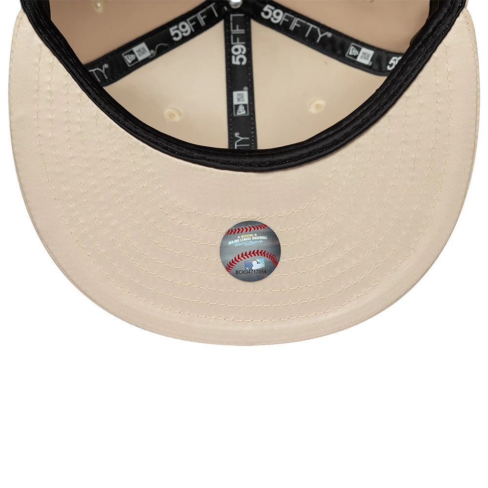 LA Dodgers MLB Satin Cream New Era 59FIFTY Fitted Cap, inside view showing the cream undervisor with a sports sticker, black taping with white 59FIFTY logos, and stitching details on the visor.