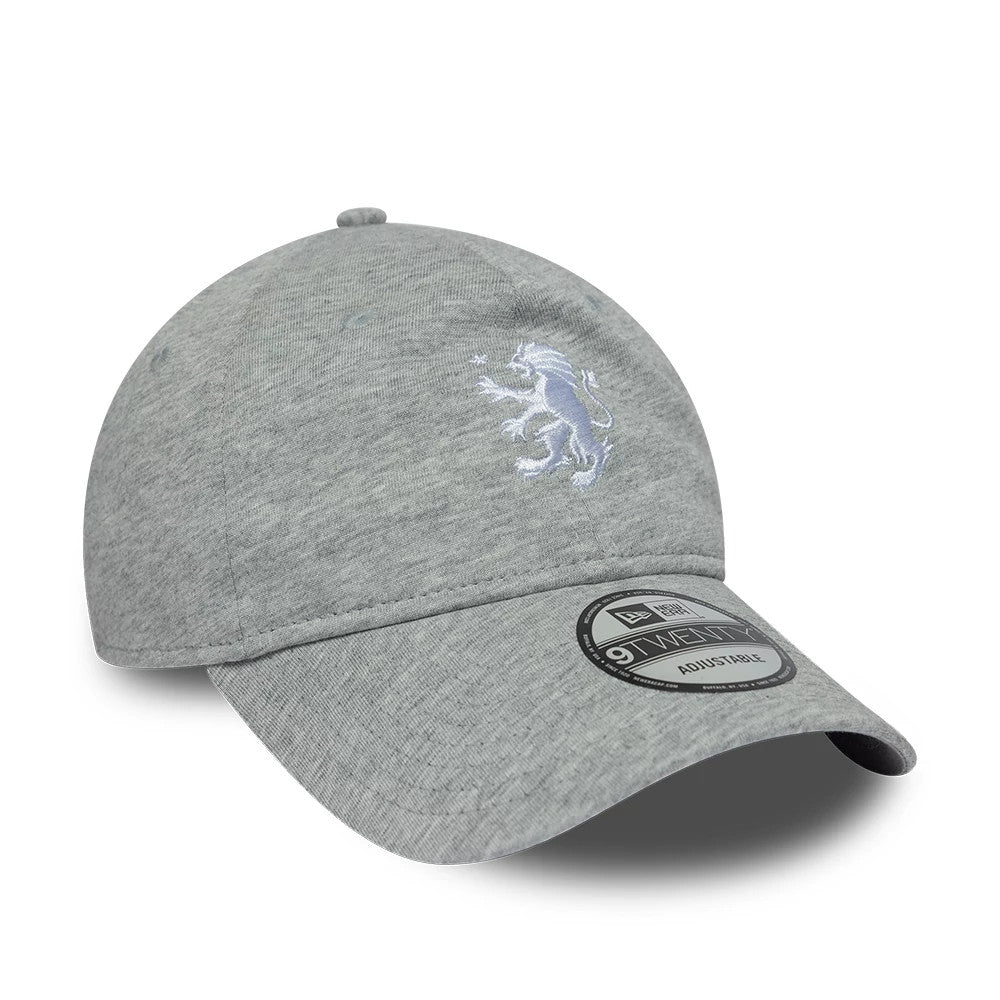 Aston Villa FC Jersey Grey New Era 9TWENTY Adjustable Cap, three-quarter view showing the white embroidered lion logo on the front panel, curved grey visor with 9TWENTY size sticker, and a top button for added detail.