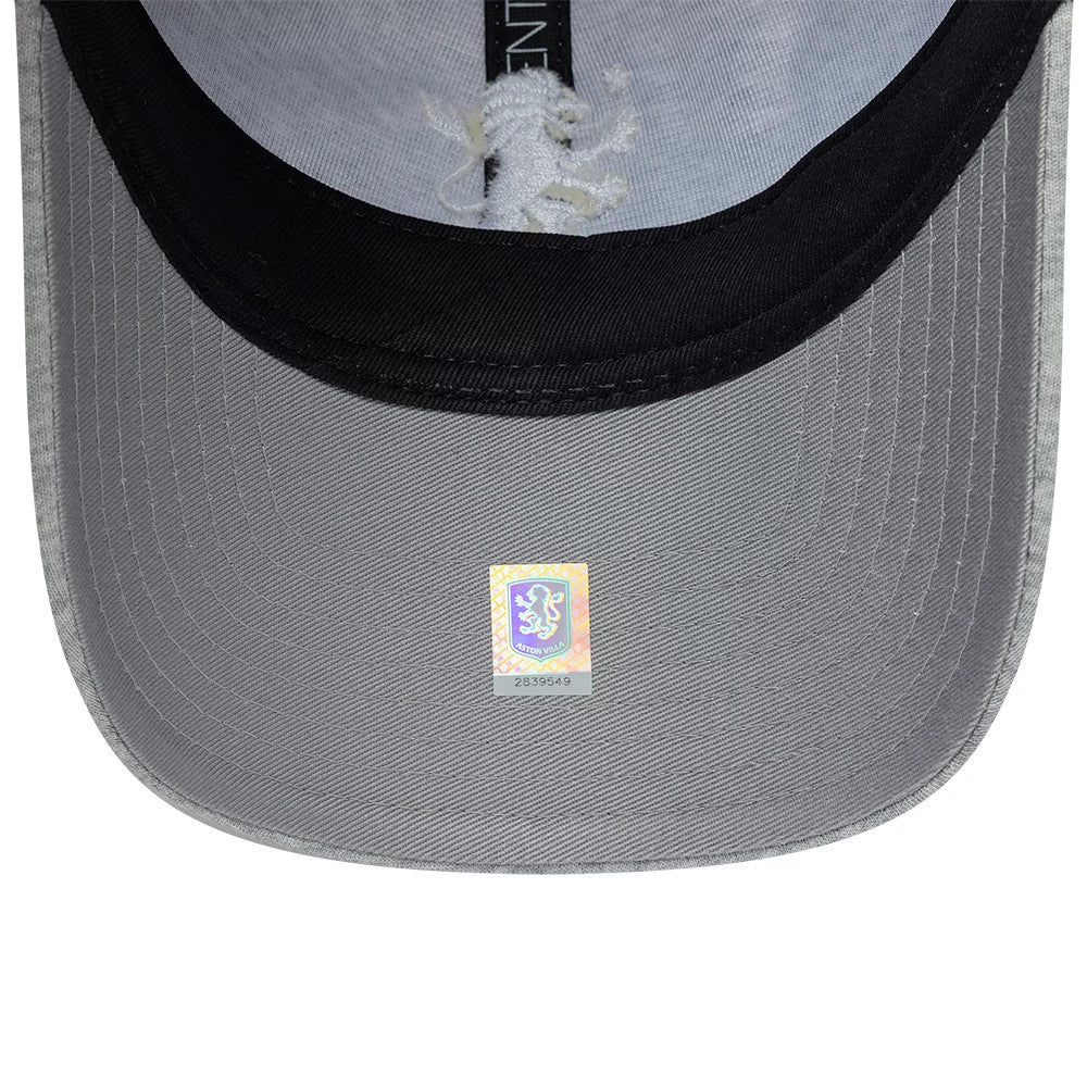 Aston Villa FC Jersey Grey New Era 9TWENTY Adjustable Cap, inside view showing the light grey undervisor with a holographic authenticity sticker, contrasting black sweatband, and branded taping running centrally across the interior.