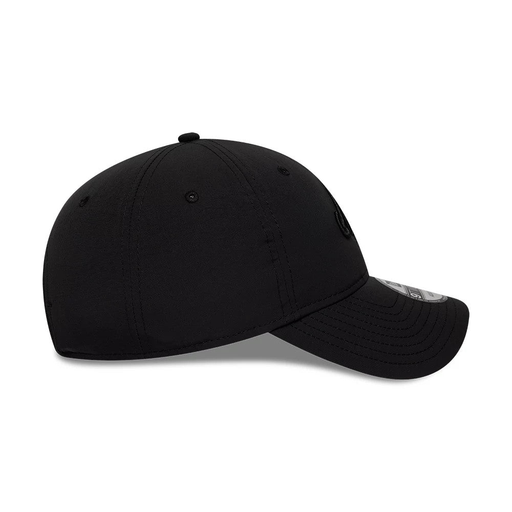 New Era Recycled Black On Black 9TWENTY Adjustable Cap, side view showing the New Era flag logo on the left side, curved visor with 9TWENTY size sticker, and a low-profile structured crown with matching black eyelets and top button.