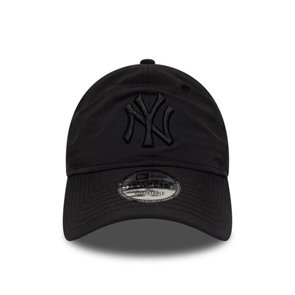 New York Yankees MLB Recycled Black On Black New Era 9TWENTY Adjustable Cap, front view showing the black raised embroidered NY logo on the front panel, a curved visor with a 9TWENTY size sticker, and a black top button.