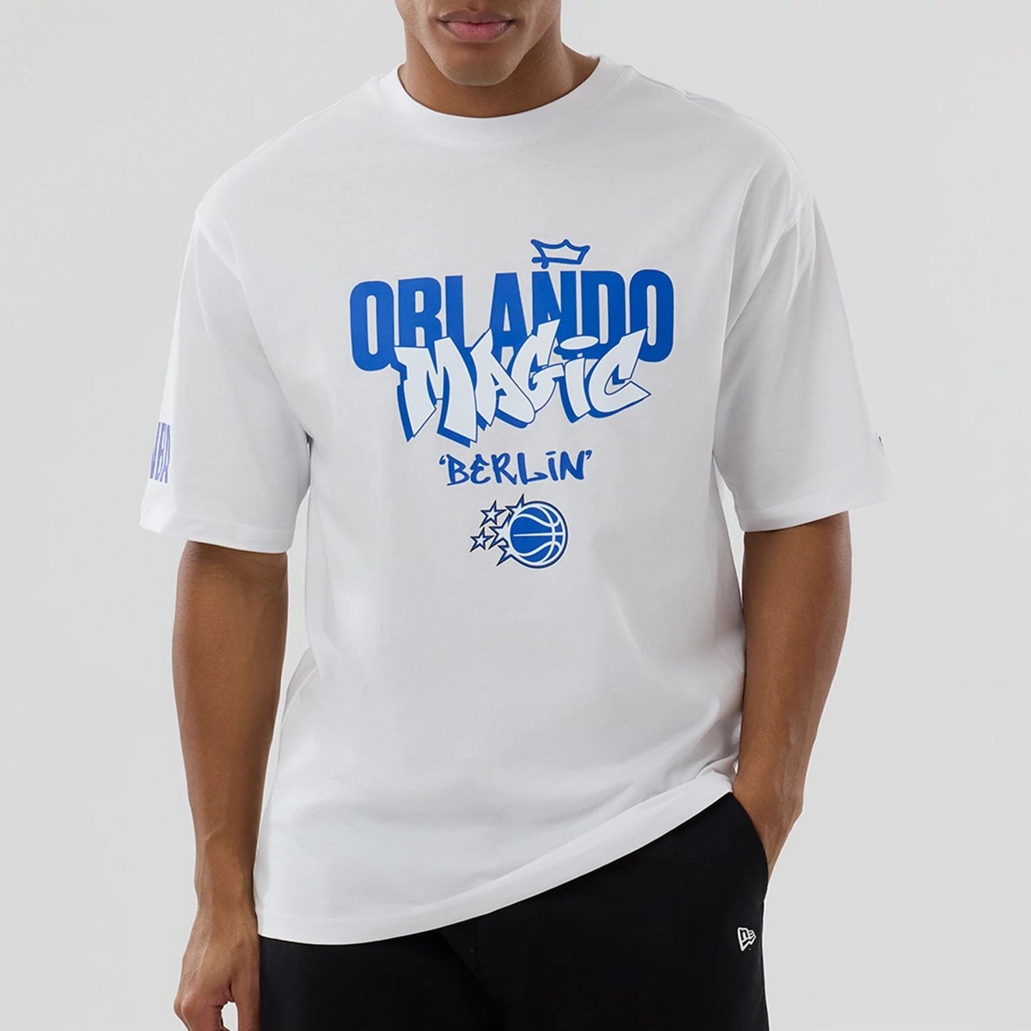 The model is wearing this NBA Berlin Game 2026 Orlando Magic Oversized T-Shirt in white. 6