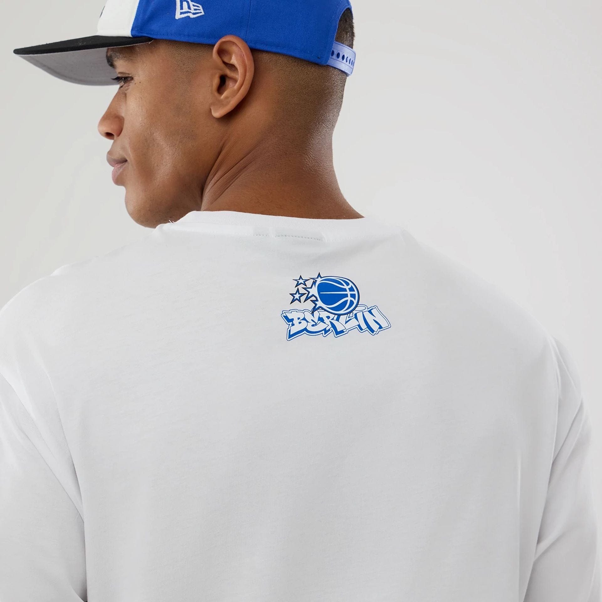 The model is wearing this NBA Berlin Game 2026 Orlando Magic Oversized T-Shirt in white. 7