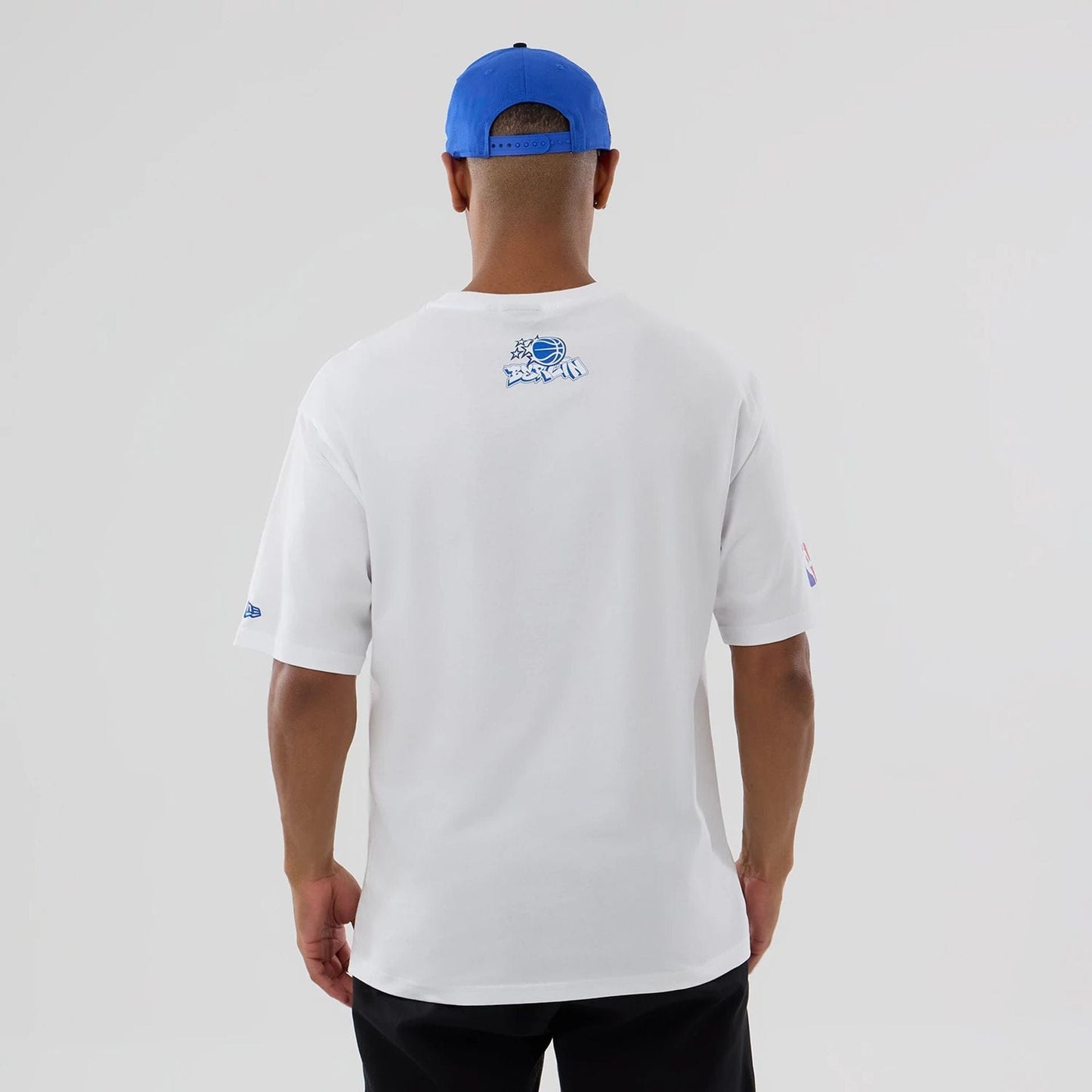 The model is wearing this NBA Berlin Game 2026 Orlando Magic Oversized T-Shirt in white. 2