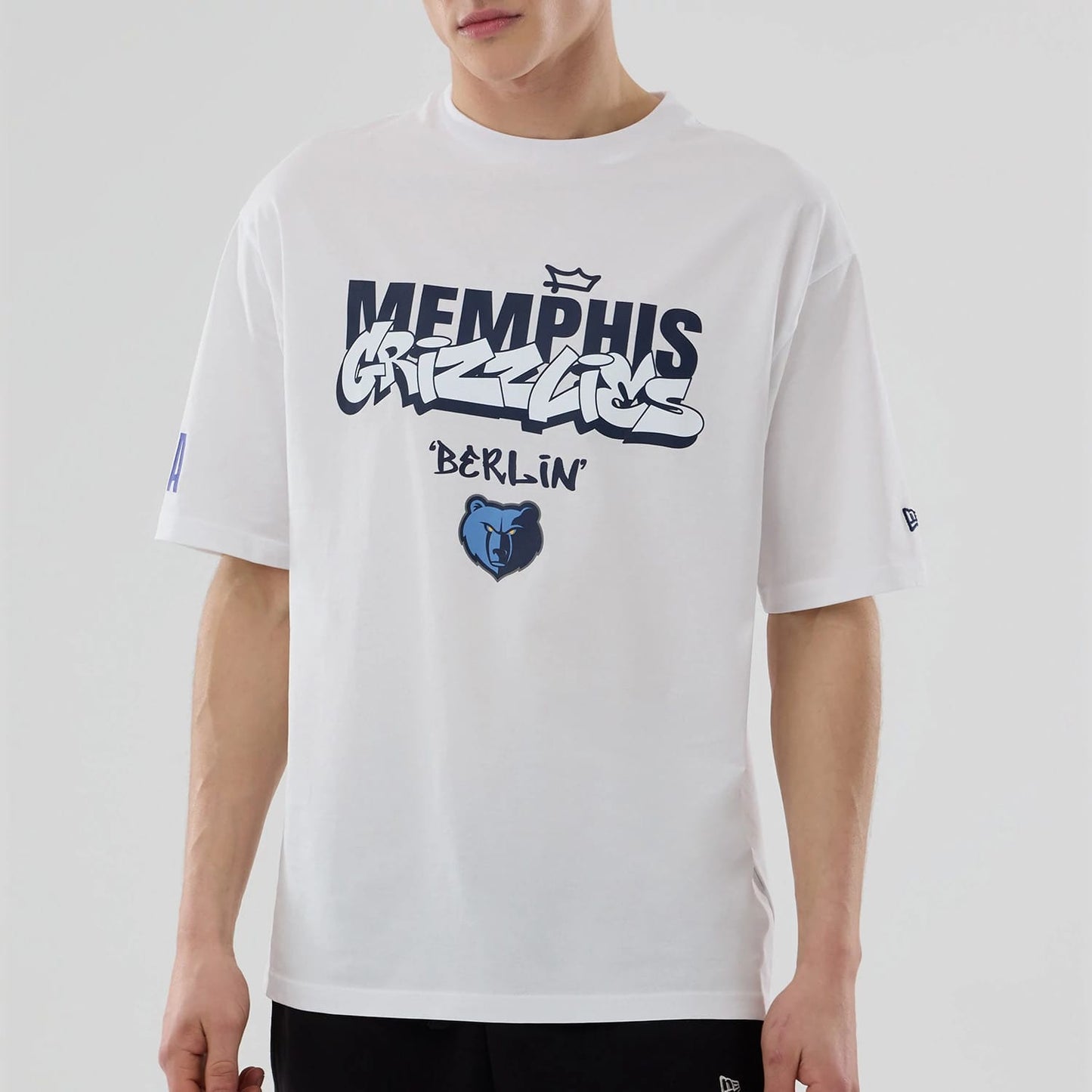 The model is wearing this NBA Berlin Game 2026 Memphis Grizzlies Oversized T-Shirt in white. 4