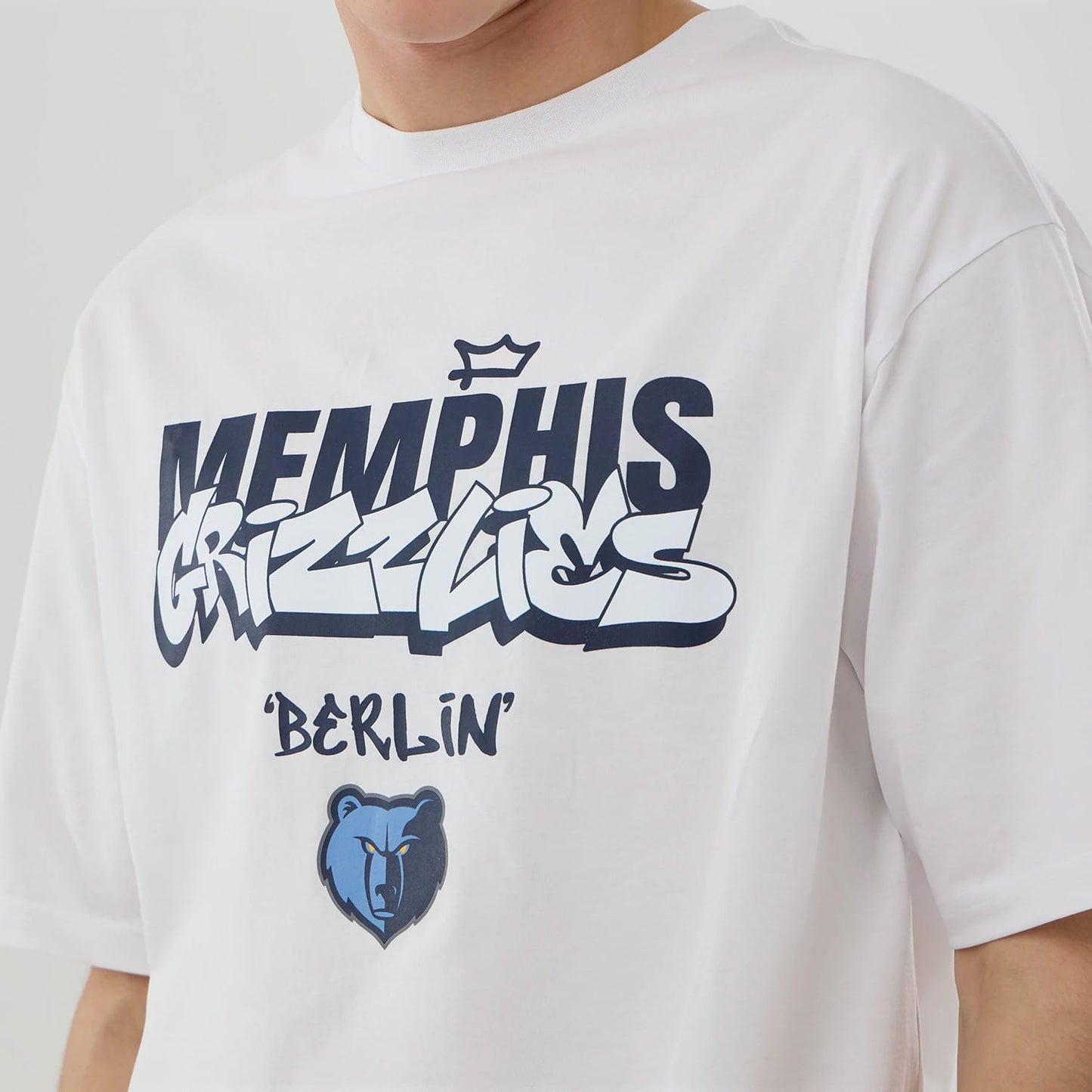 The model is wearing this NBA Berlin Game 2026 Memphis Grizzlies Oversized T-Shirt in white. 3