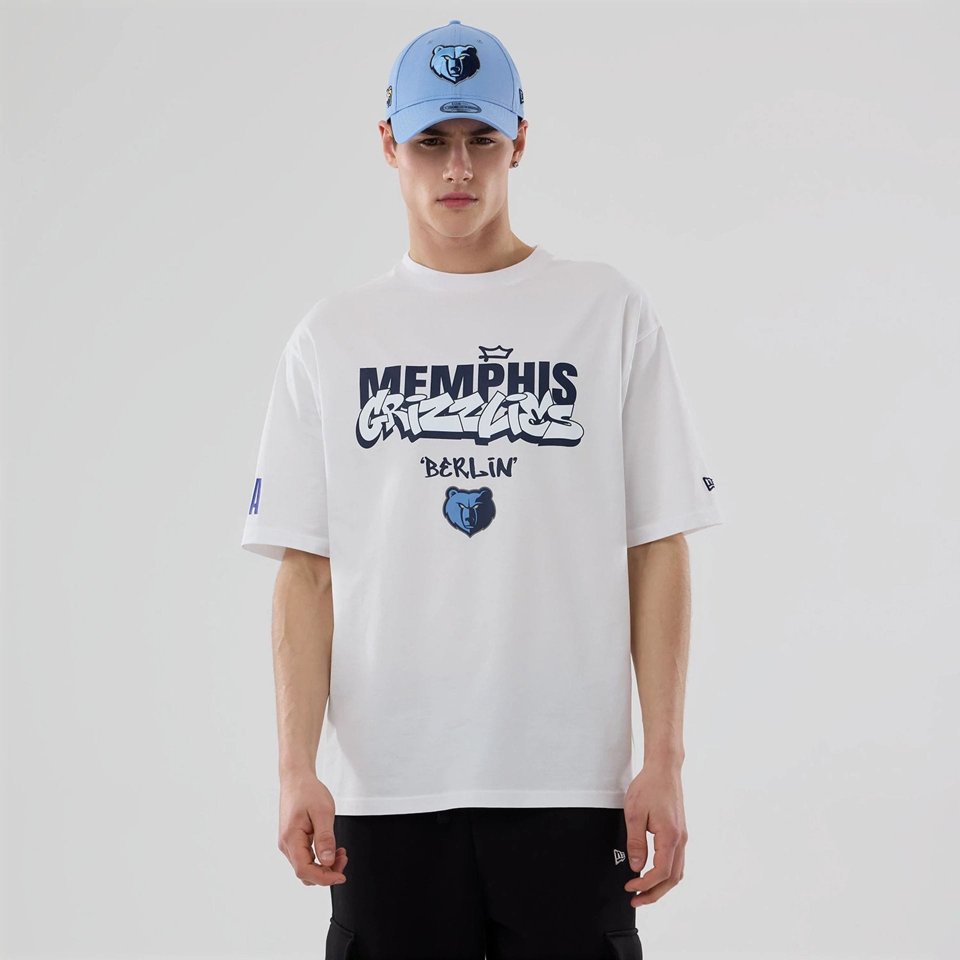The model is wearing this NBA Berlin Game 2026 Memphis Grizzlies Oversized T-Shirt in white.  1