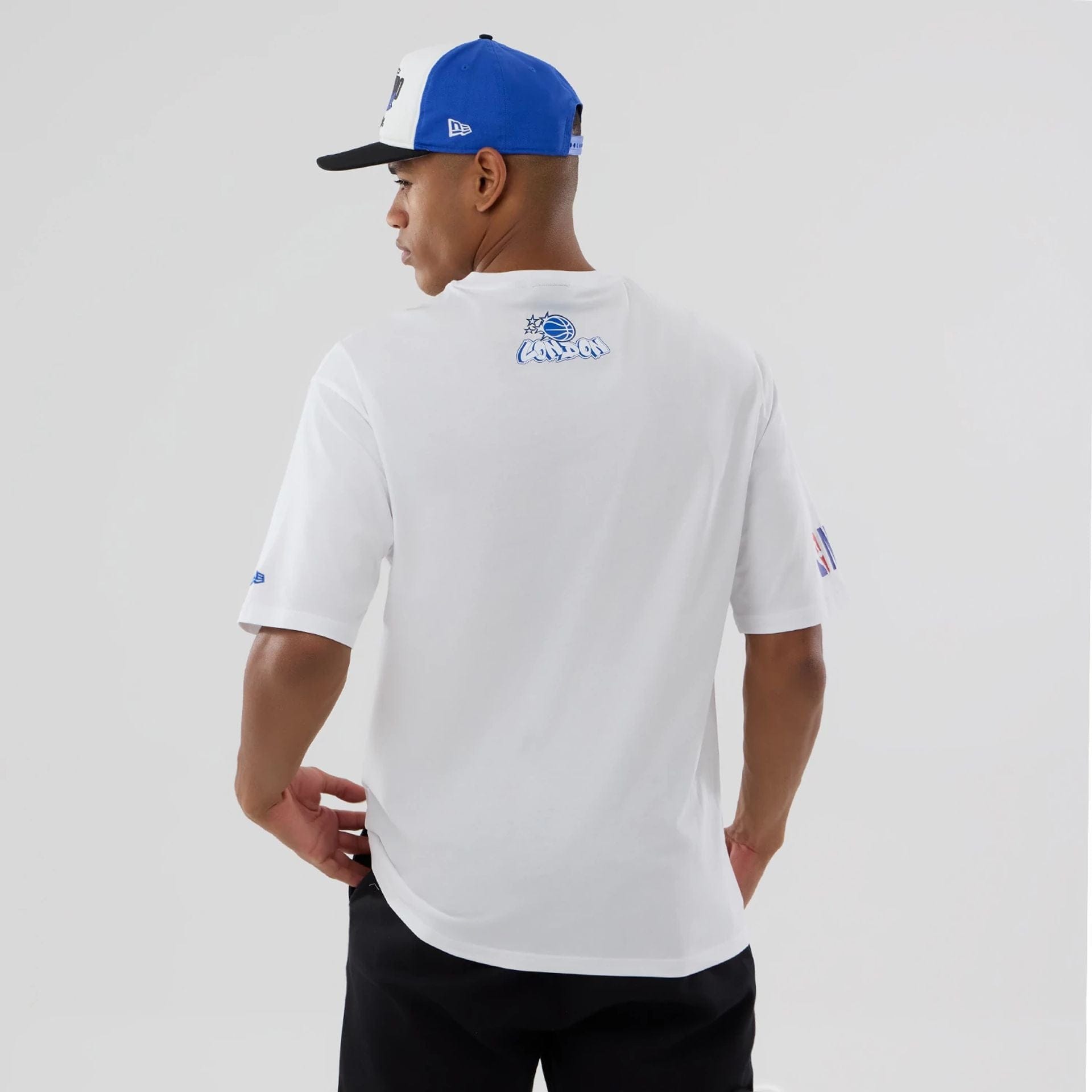 The model is wearing this NBA London Game 2026 Orlando Magic Oversized T-Shirt in white. 2