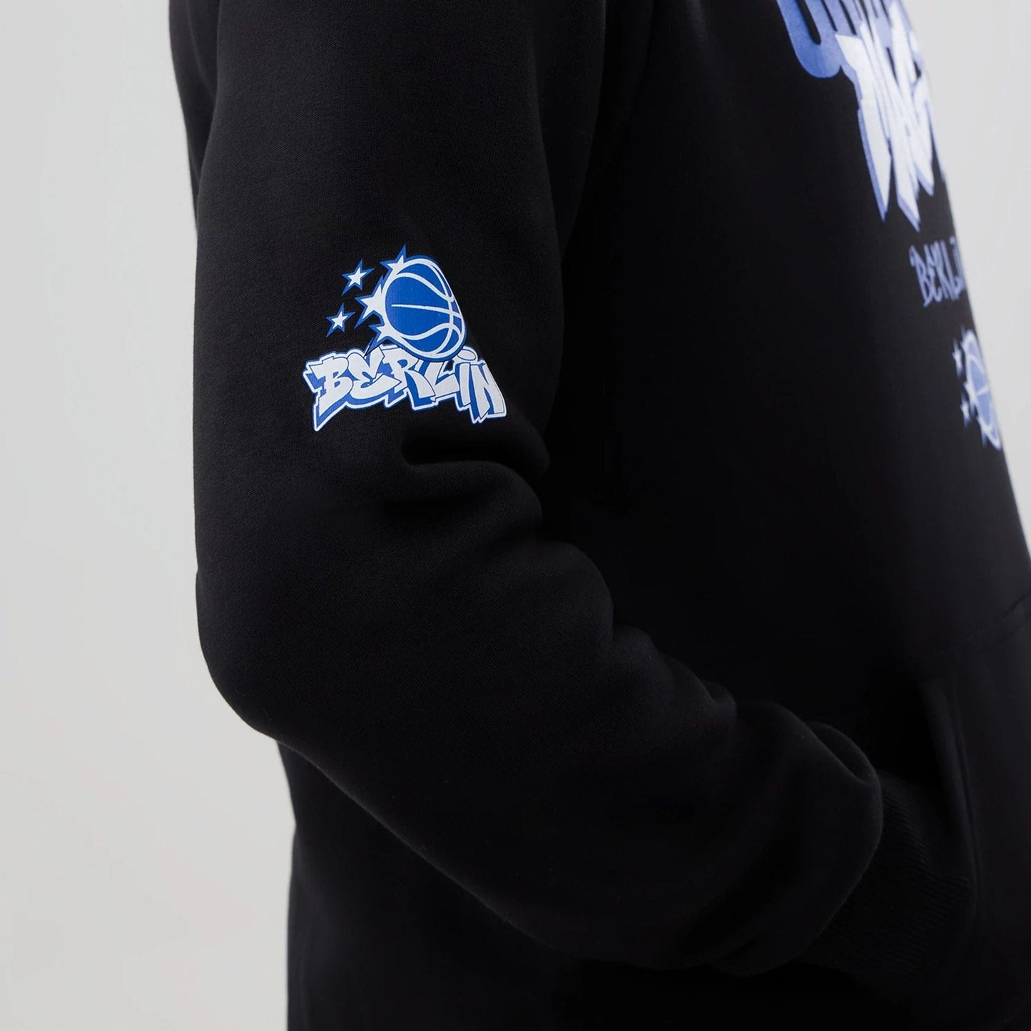 The model is wearing this NBA Berlin Game 2026 Orlando Magic Pullover Hoodie in black. 3