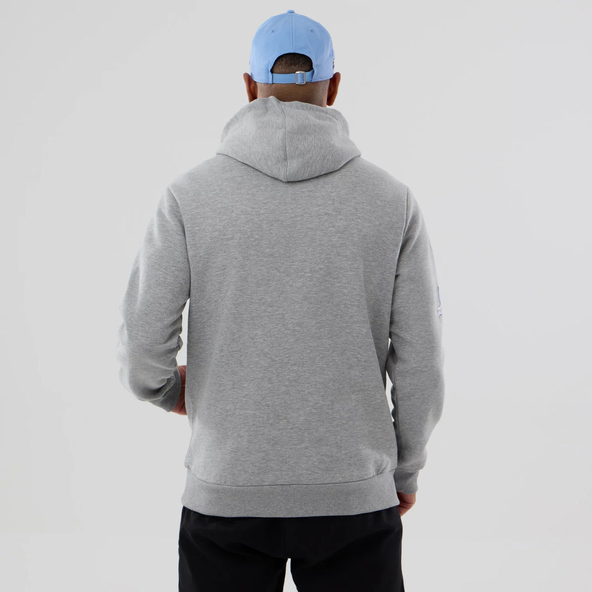 New Era Memphis Grizzlies NBA Berlin Game 2026 Grey Pullover Hoodie, back view on a model wearing a light blue cap, showing the plain grey hood resting flat against the upper back and sleeves extending down to the wrists.
