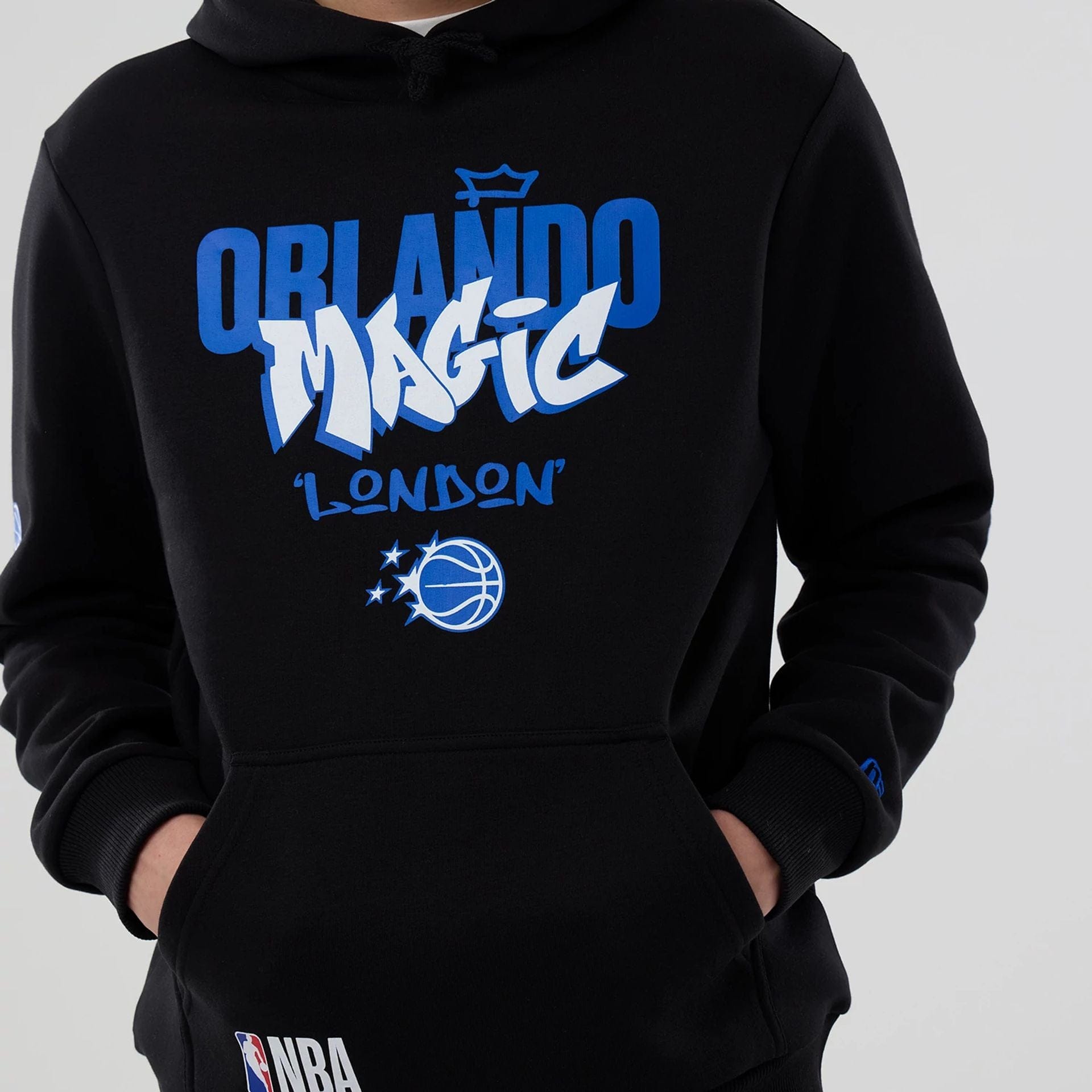 The model is wearing this NBA London Game 2026 Orlando Magic Pullover Hoodie in black. 4