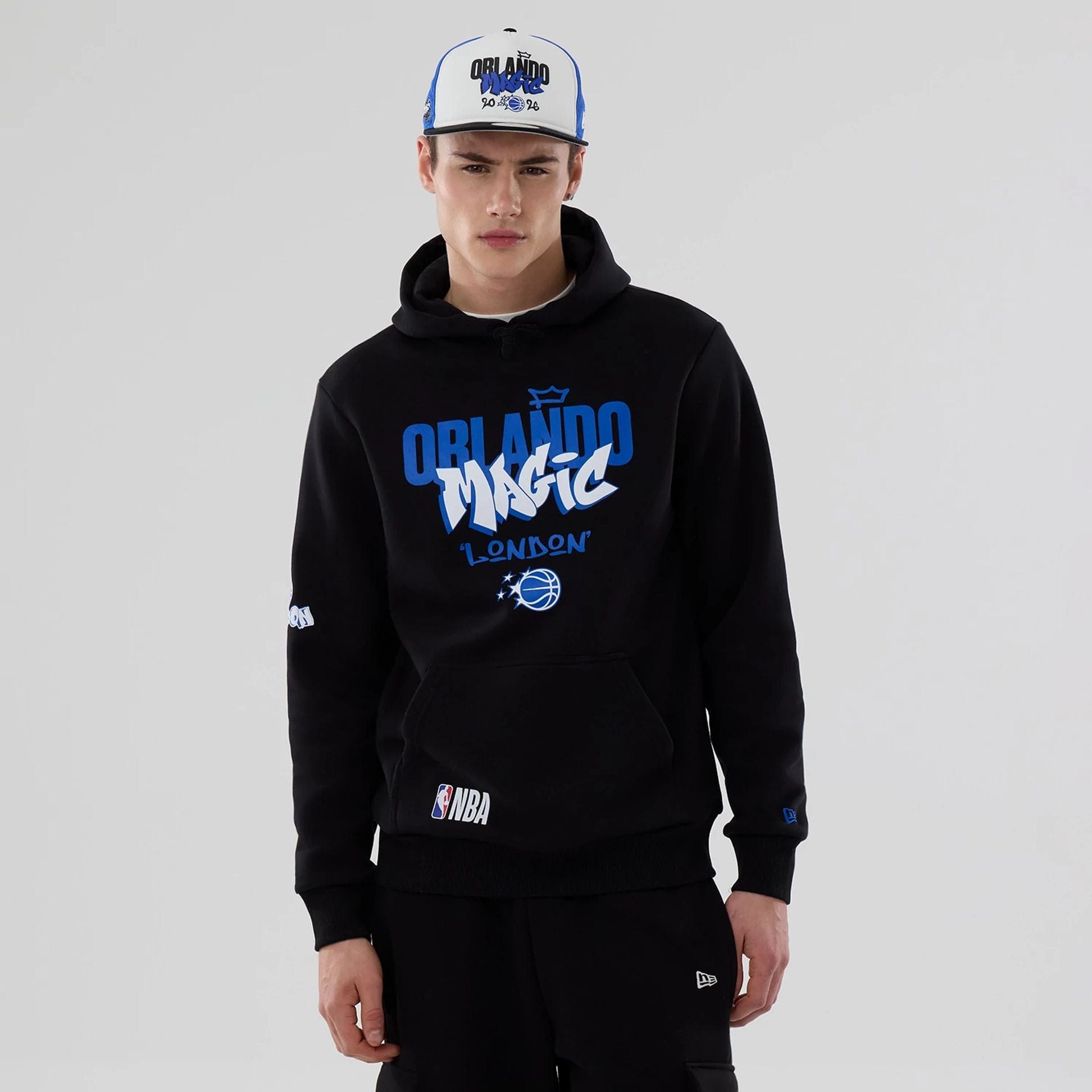 The model is wearing this NBA London Game 2026 Orlando Magic Pullover Hoodie in black. 1