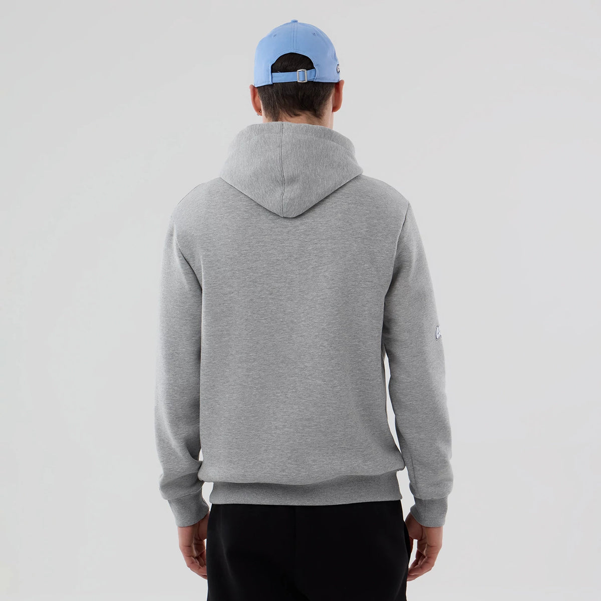 New Era Memphis Grizzlies NBA London Game 2026 Grey Pullover Hoodie, back view on a model, displaying a plain grey design with a relaxed hood, ribbed cuffs, and hem, with a small embroidered logo on the left sleeve.