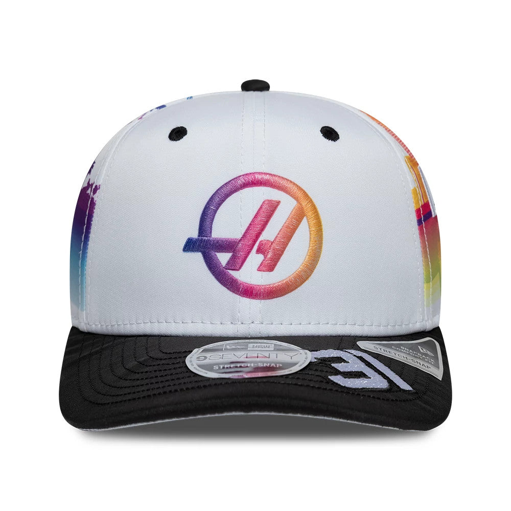 TGR Haas F1 Esteban Ocon Miami Race Special White New Era 9SEVENTY Stretch Snap Cap, front view showing a multicoloured embroidered Haas logo on the structured white crown, with a contrasting black visor and 9SEVENTY size sticker.