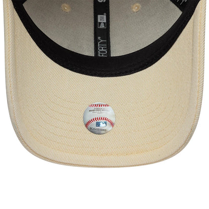 New York Mets MLB Washed Denim Light Beige New Era 9FORTY Adjustable Cap, inside view showing a light beige undervisor with a baseball-themed sticker, black taping with branding, and circular beige reinforcement around the eyelets.