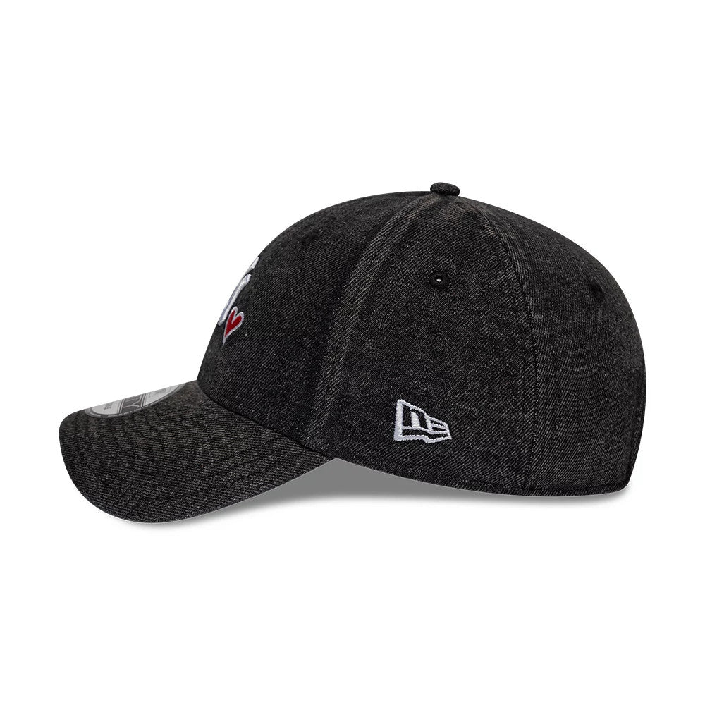 New York Yankees MLB Washed Denim Black New Era 9FORTY Adjustable Cap, side view showing the white New Era flag logo on the left side, a curved visor, and black embroidered eyelets on the black washed denim fabric.