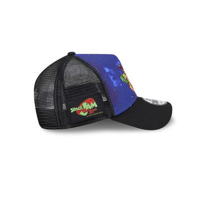 Space Jam Rivalry Black New Era 9FORTY A-Frame Trucker Adjustable Cap, side view showing a colourful Space Jam 30th Anniversary patch on the mesh panel, a galaxy-themed front panel, and a bent black visor with a 9FORTY size sticker.