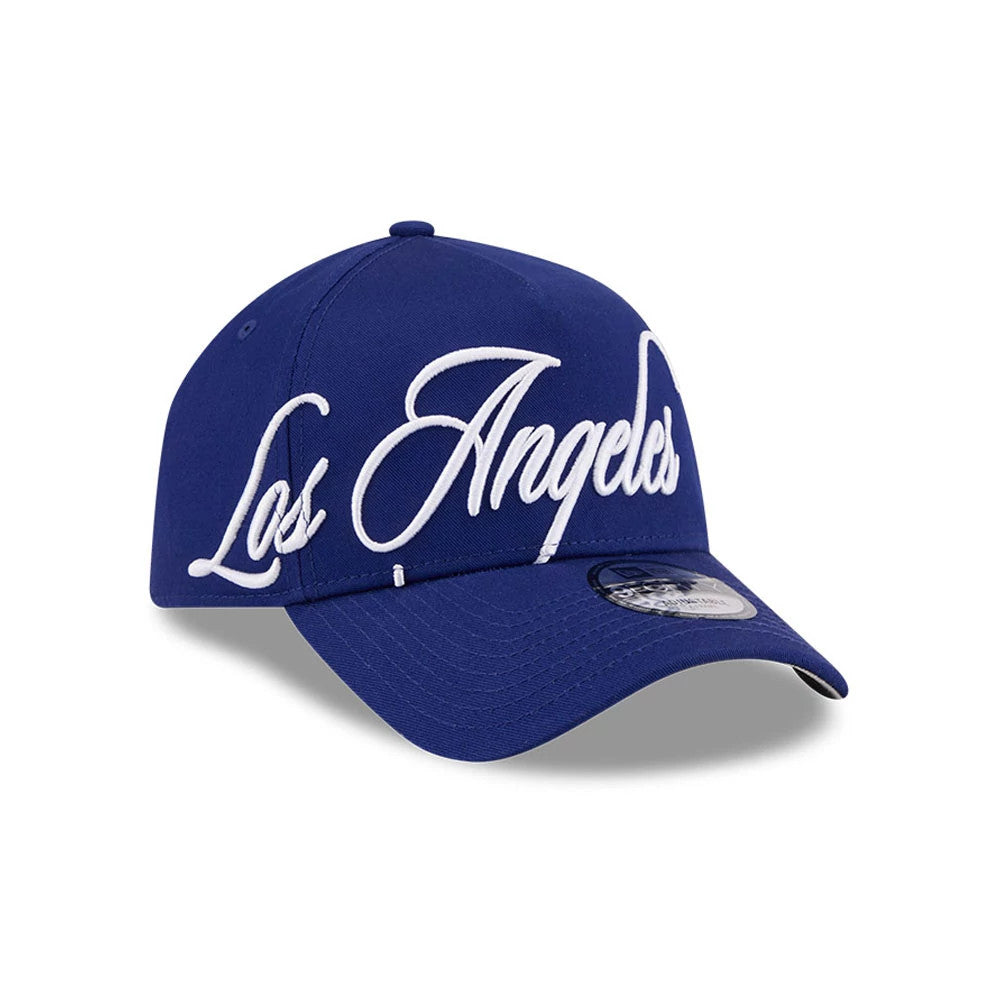 LA Dodgers MLB Calligraphy Dark Blue New Era 9FORTY A-Frame Adjustable Cap, three-quarter view showing the white Los Angeles script embroidered across the front panel, with a dark blue curved visor and 9FORTY size sticker on the top.