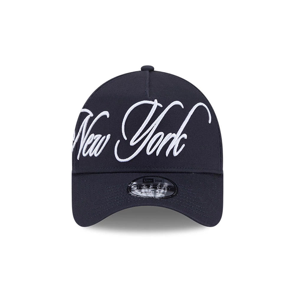 New York Yankees MLB Calligraphy Navy New Era 9FORTY A-Frame Adjustable Cap, front view showing the white embroidered New York lettering across the structured navy crown, with a curved visor and a 9FORTY size sticker on the centre front.