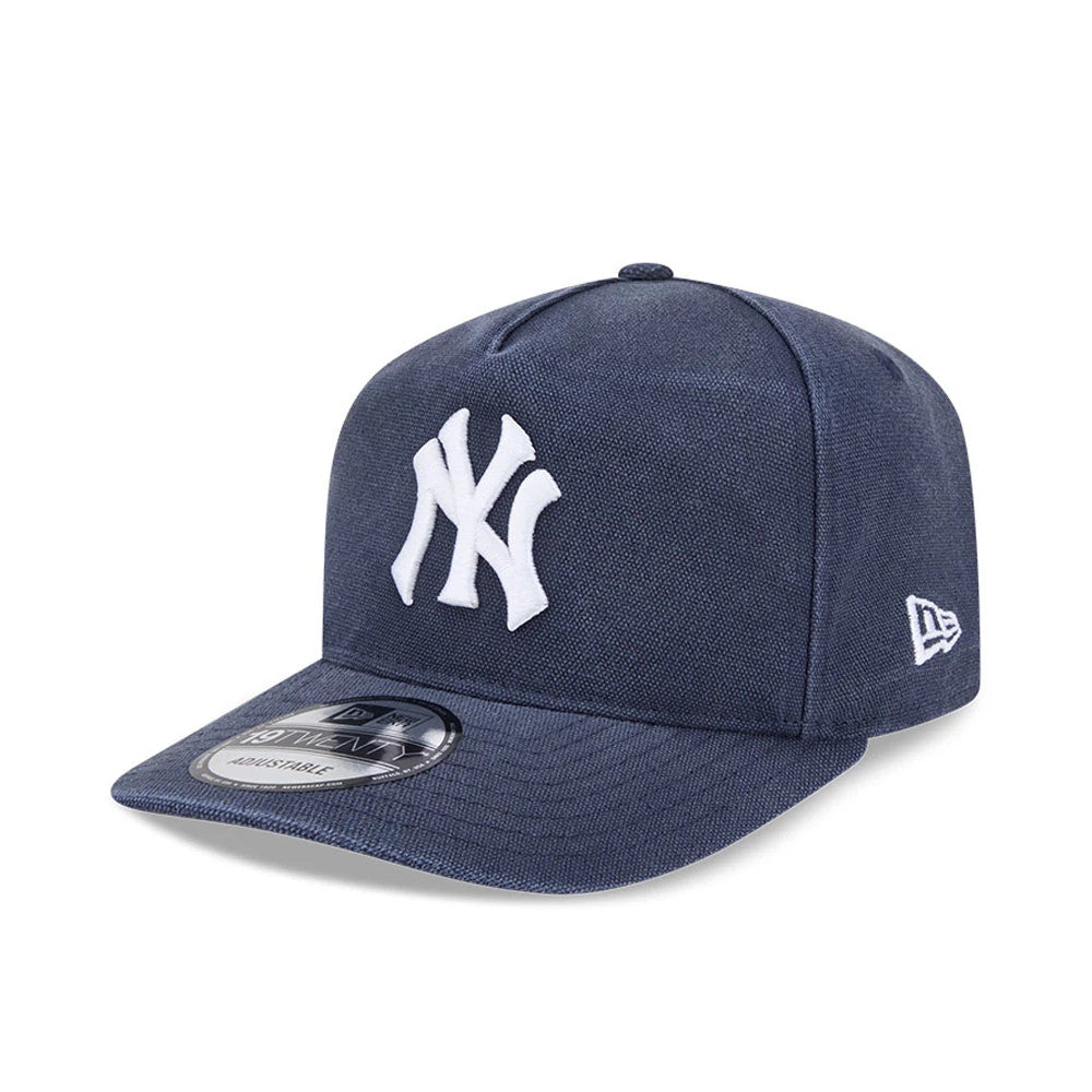 New York Yankees MLB Duck Canvas Navy New Era 19TWENTY Adjustable Cap, three-quarter view showing the raised white embroidered NY logo on the front panel, a navy visor with a 19TWENTY size sticker, and the New Era flag logo on the left side.