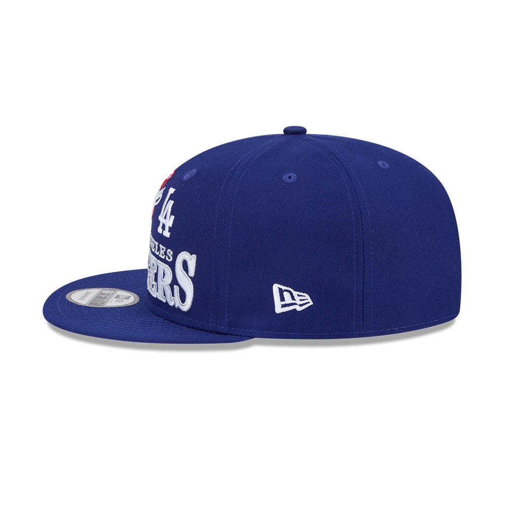 LA Dodgers MLB Cooperstown Throwback Blue New Era 9FIFTY Snapback Adjustable Cap, side view showing the white embroidered New Era flag logo on the left side, a structured blue crown, and a flat blue visor with a 9FIFTY size sticker on top.