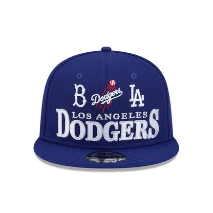 LA Dodgers MLB Cooperstown Throwback Blue New Era 9FIFTY Snapback Adjustable Cap, front view showing raised white embroidered Los Angeles Dodgers lettering, classic team logos on the blue structured crown, and a 9FIFTY size sticker on the flat visor.