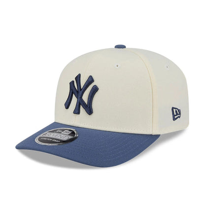 Pictured is this MLB Slate Stone New York Yankees 9SEVENTY Stretch Snap cap in cream & dark blue. 1