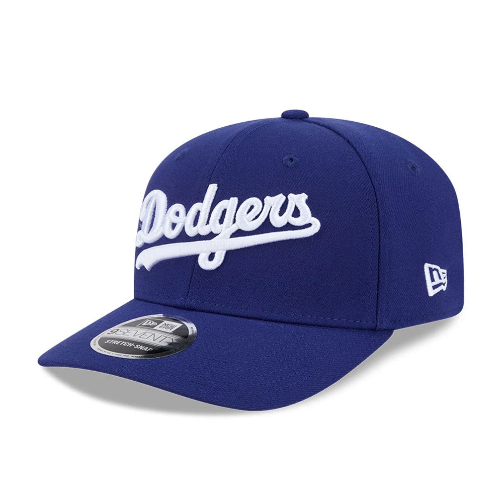 LA Dodgers MLB Dark Blue New Era 9SEVENTY Stretch Snap Adjustable Cap, three-quarter view showing the raised white embroidered Dodgers script on the front panel, dark blue structured crown with eyelets, and 9SEVENTY size sticker on the curved visor.