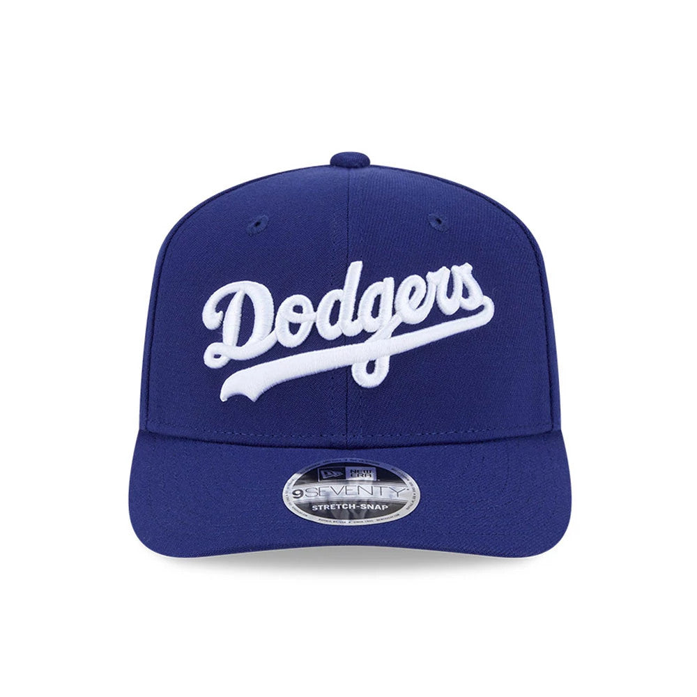 LA Dodgers MLB Dark Blue New Era 9SEVENTY Stretch Snap Adjustable Cap, front view showing the white embroidered Dodgers script logo on the structured dark blue crown, complemented by a slightly curved visor and 9SEVENTY size sticker.