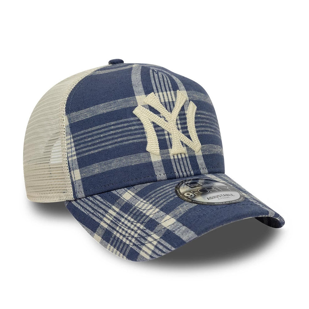 Ralph Lauren X MLB Yankees Blue New Era 9FORTY A-Frame Trucker Adjustable Cap, three-quarter view showing the cream embroidered NY logo on a blue plaid front panel, beige mesh back panels, and a 9FORTY size sticker on the curved visor.
