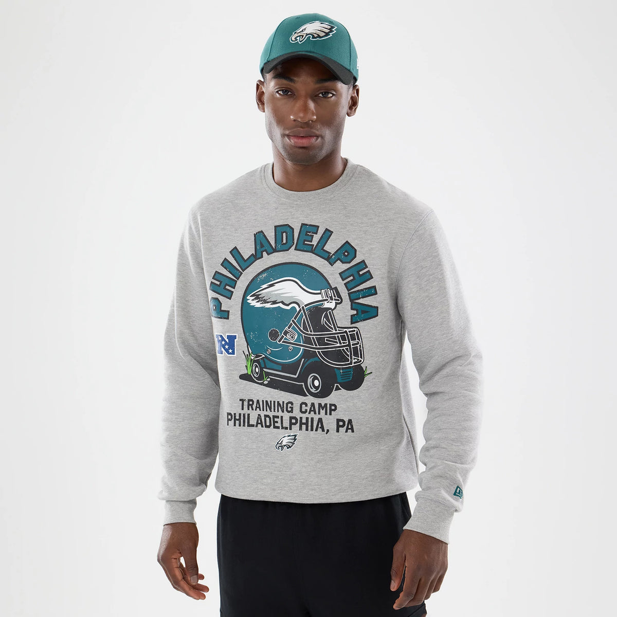 The model is wearing this NFL Training 2026 Philadelphia Eagles Crew Neck Sweater in grey. 1