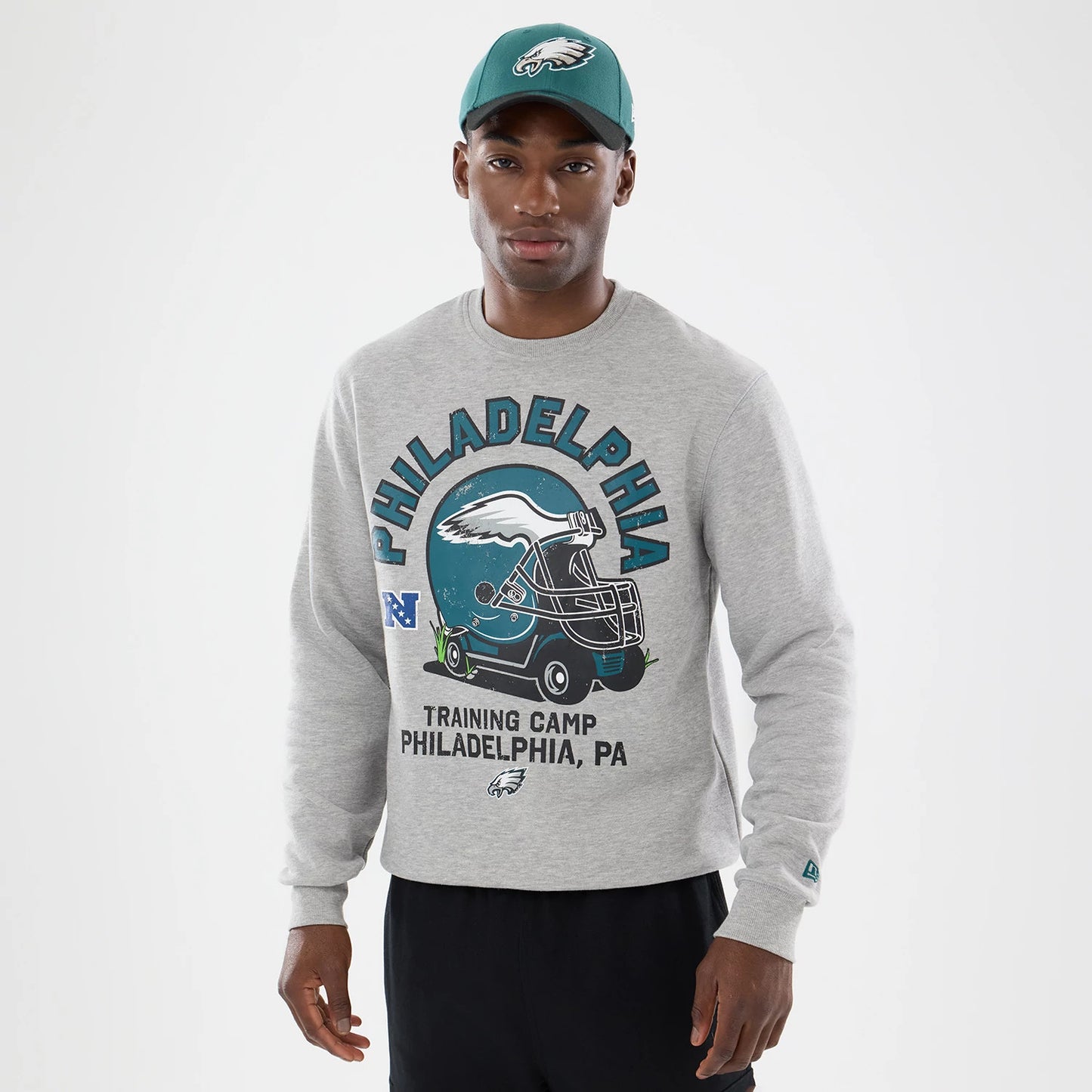 The model is wearing this NFL Training 2026 Philadelphia Eagles Crew Neck Sweater in grey. 1