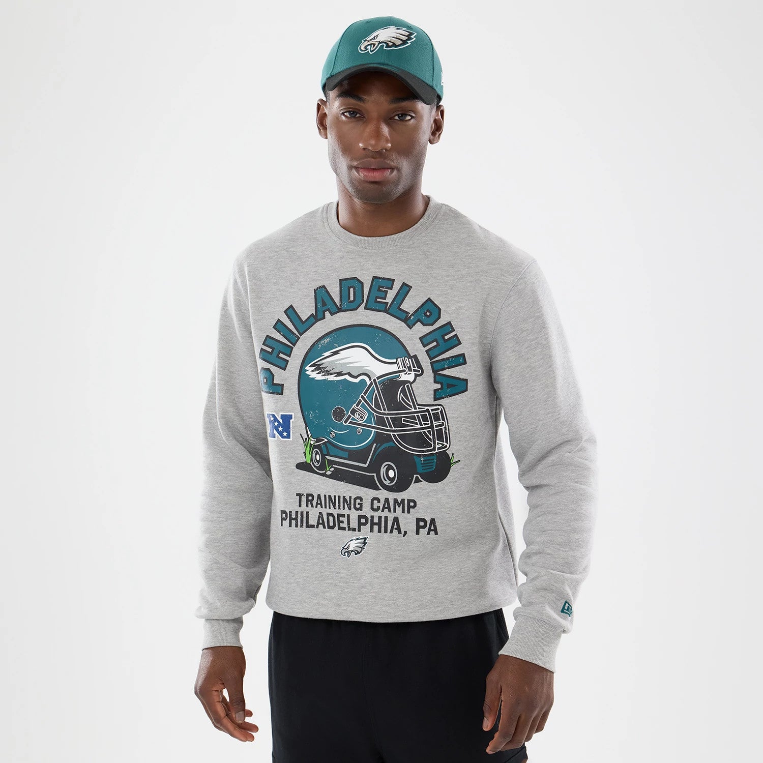 The model is wearing this NFL Training 2026 Philadelphia Eagles Crew Neck Sweater in grey. 1
