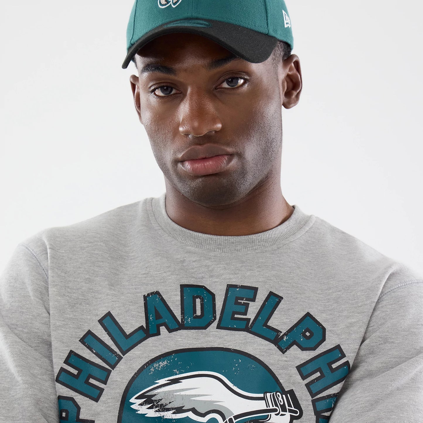 The model is wearing this NFL Training 2026 Philadelphia Eagles Crew Neck Sweater in grey. 4