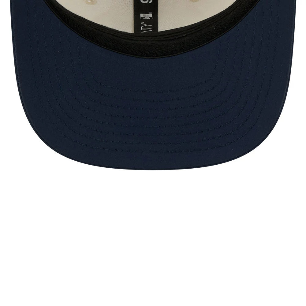 Patriots NFL Training 2026 White New Era 9SEVENTY Stretch Snap Adjustable Cap, inside view showing the black sweatband and black taping with white text running along the crown, and a navy blue undervisor beneath the structured panels.