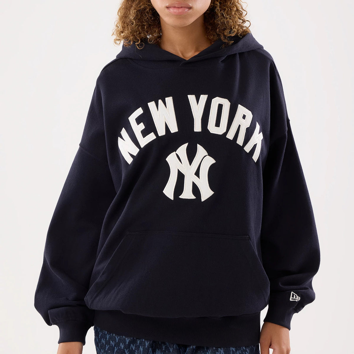 The model is wearing this Womens MLB New York Yankees Oversized Pullover Hoodie in navy. 3