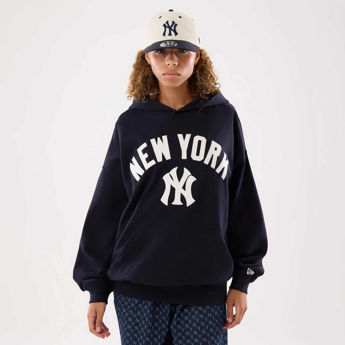 The model is wearing this Womens MLB New York Yankees Oversized Pullover Hoodie in navy. 1