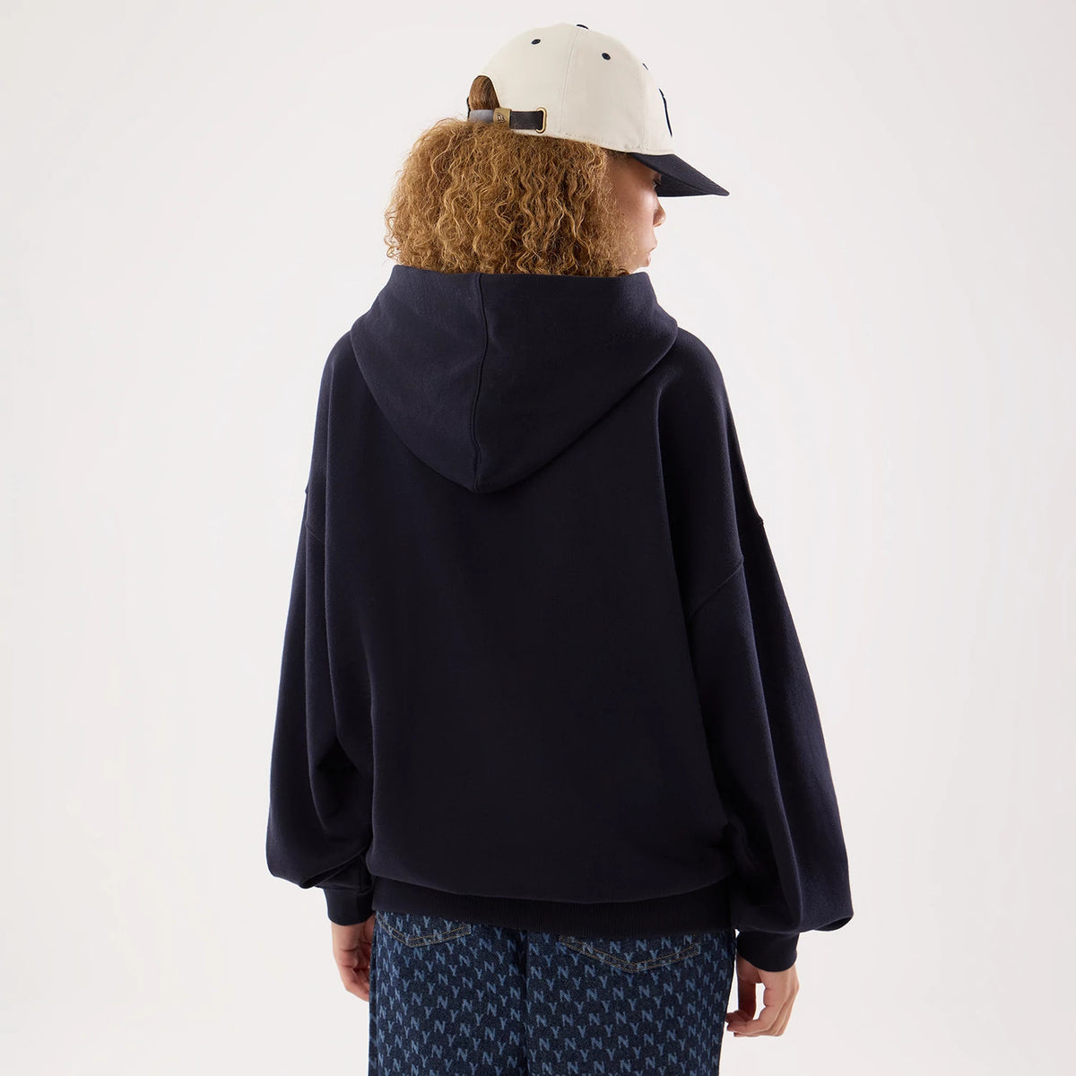 The model is wearing this Womens MLB New York Yankees Oversized Pullover Hoodie in navy. 2