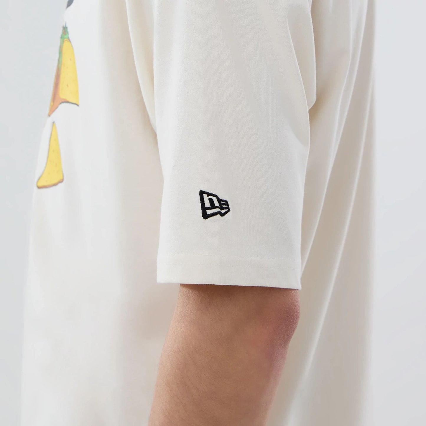 The model is wearing this MLB Food Graphic LA Dodgers Oversized T-Shirt in open white. 5