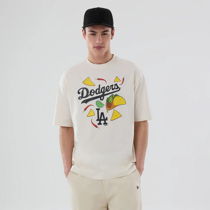 The model is wearing this MLB Food Graphic LA Dodgers Oversized T-Shirt in open white. 1