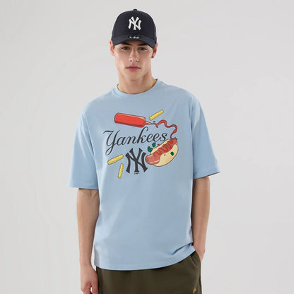 The model is wearing this MLB Food Graphic New York Yankees Oversized T-Shirt in pastel blue. 1