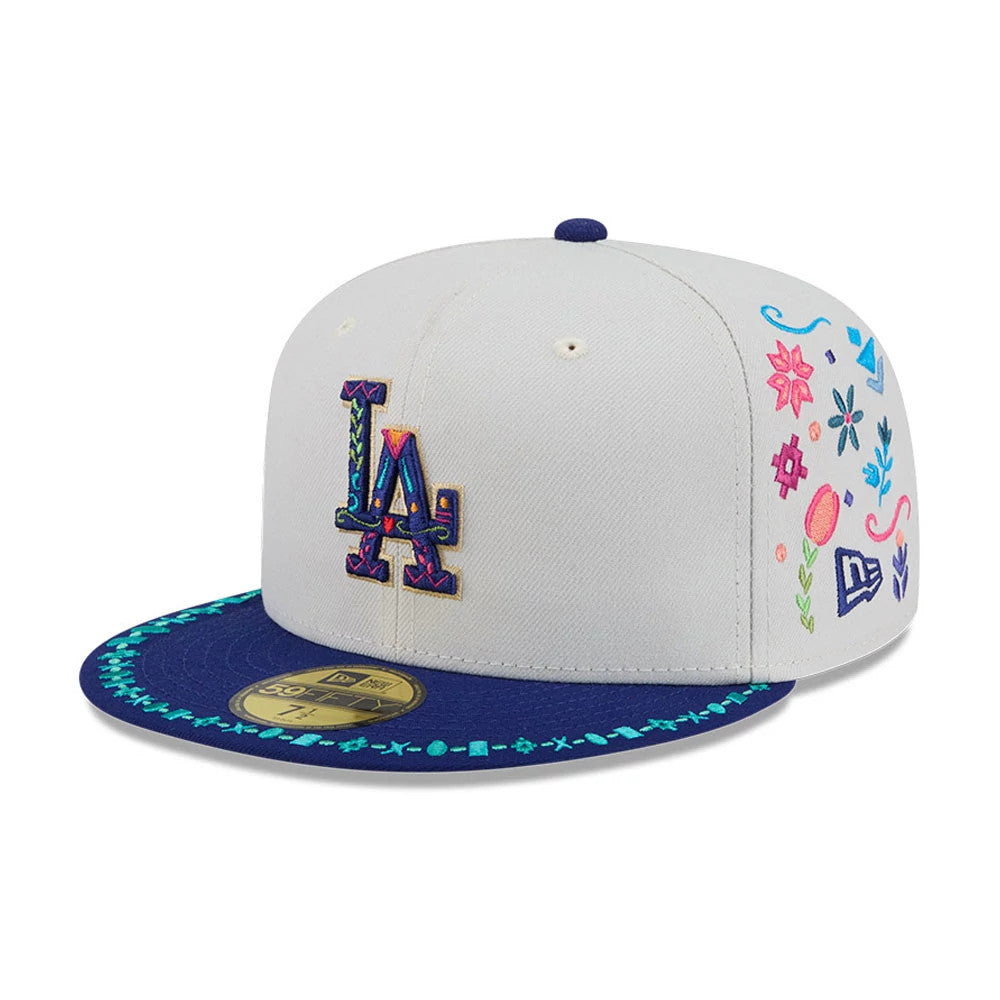 LA Dodgers MLB Heritage Light Beige New Era 59FIFTY Fitted Cap, front view showing the multicoloured embroidered LA logo on the light beige crown, a navy visor with turquoise pattern along the edge and a gold 59FIFTY size sticker.