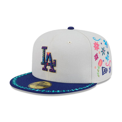 LA Dodgers MLB Heritage Light Beige New Era 59FIFTY Fitted Cap, front view showing the multicoloured embroidered LA logo on the light beige crown, a navy visor with turquoise pattern along the edge and a gold 59FIFTY size sticker.