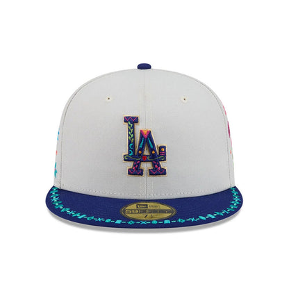 LA Dodgers MLB Heritage Light Beige New Era 59FIFTY Fitted Cap, front view showing a multicoloured embroidered LA logo on the central beige panel, with a patterned blue visor featuring contrasting stitching and a gold 59FIFTY size sticker.